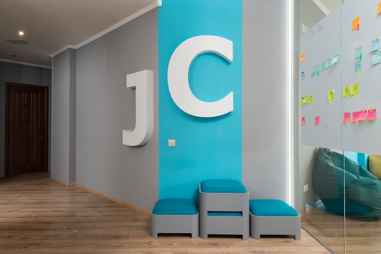 Contemporary office lobby featuring large decorative letters and glass wall with colorful notes.